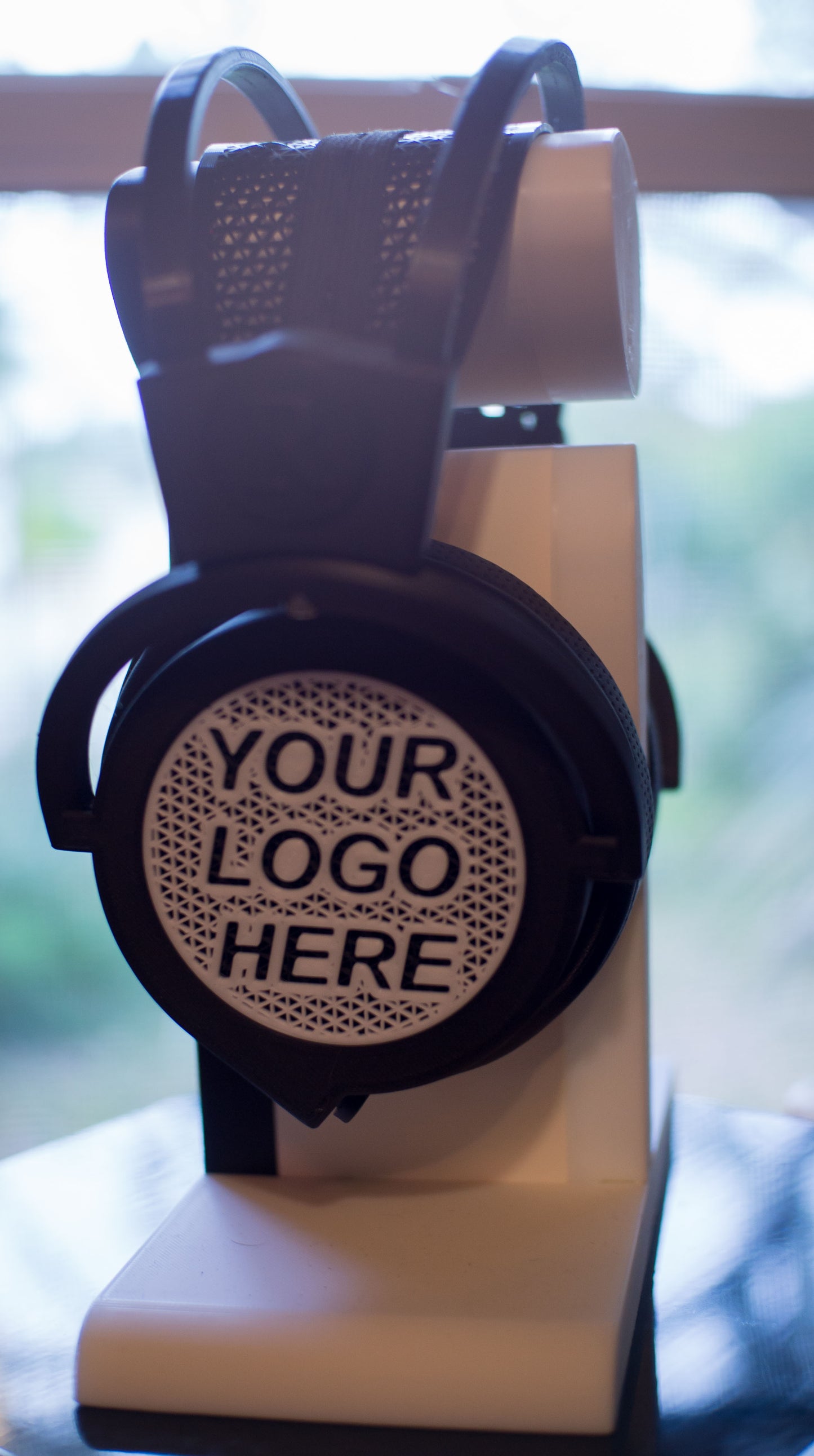 The M57 - Lyra Open Back headphone with customizable options for the headphone grill and stand.
The enclosure has been updated to move the external yoke sops internally (the square bits protruding on the sides).